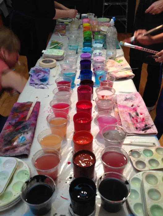 Photo of a colorful paint table at a Painting Experience workshop