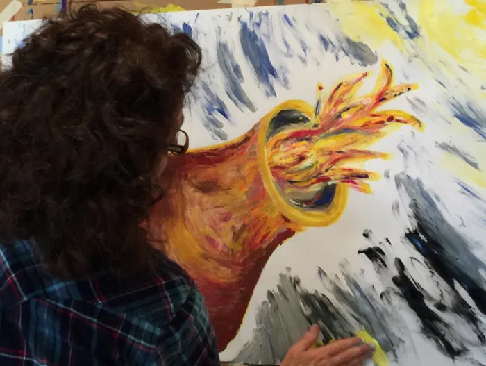 A woman participating in a Painting Experience workshop on Whidbey Island