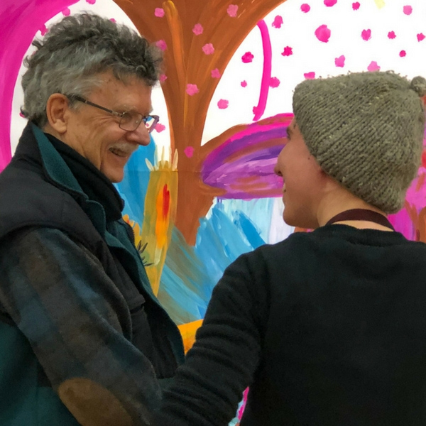Stewart Cubley and Amy Kisei Costenbxder talking in front of a process painting.
